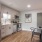 a kitchen with a dining table and refrigerator