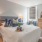 a bedroom with a bed and a mirror