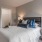 a bedroom with a bed and lamps